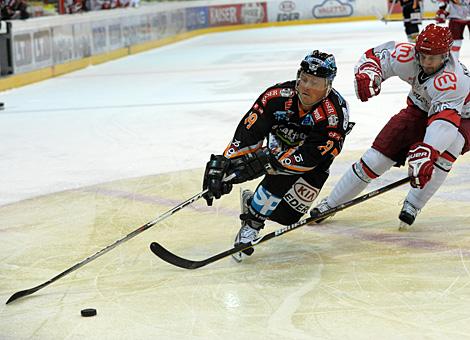Rob Shearer, Liwest Black Wings Linz im Duell um die Scheibe. 