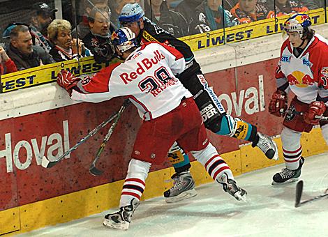 #63 Markus Schlacher, Stuermer, Liwest Black Wings im Zweikampf an der Bande mit dem Salzburger #28 Andreas Reisinger, Red Bulls Salzburg.